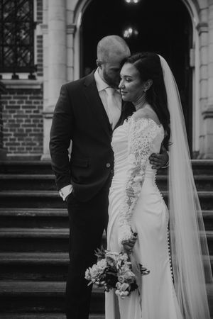 Black and white wedding photos showing couple in elegant attire with bride in lace gown and flowing veil.
