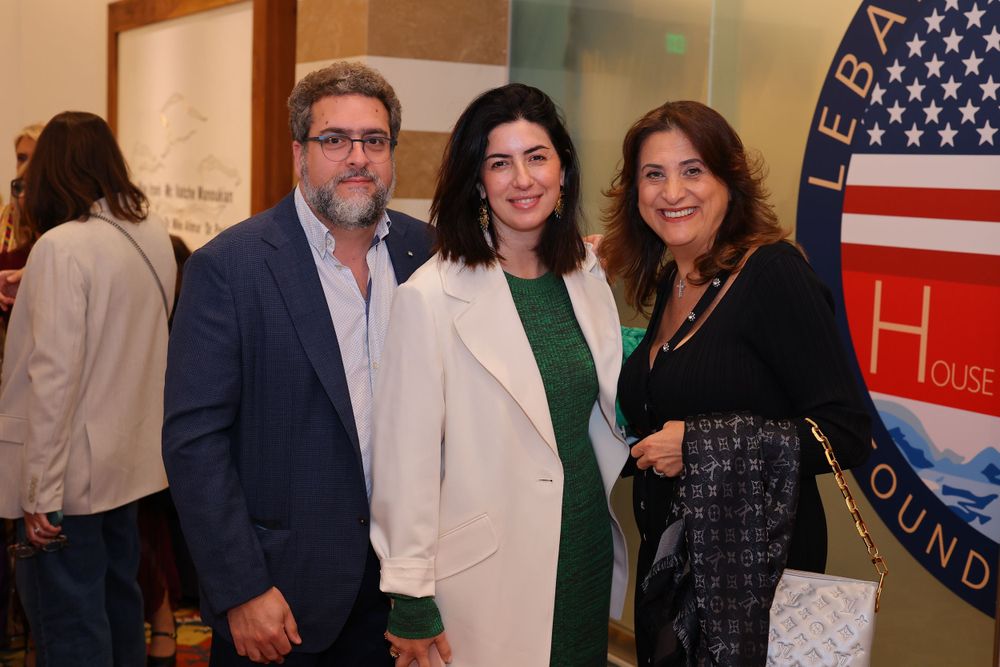 Event gathering with American and Lebanese flags visible in background.