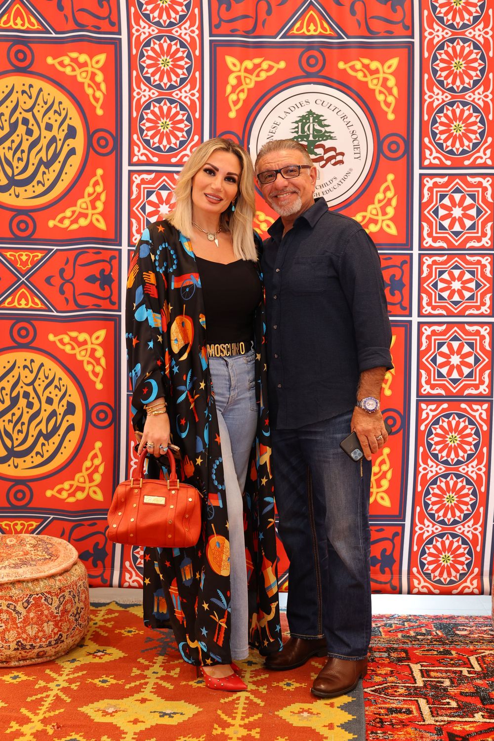 Colorful Middle Eastern patterned backdrop with decorative cedar tree emblem.