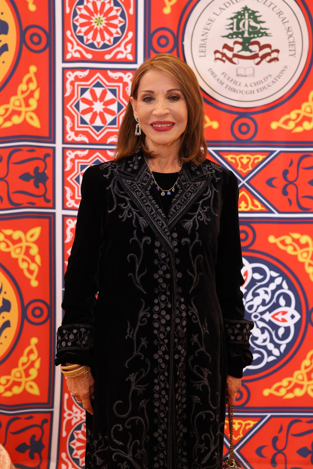 Decorative Middle Eastern backdrop featuring geometric patterns and cedar tree emblem.
