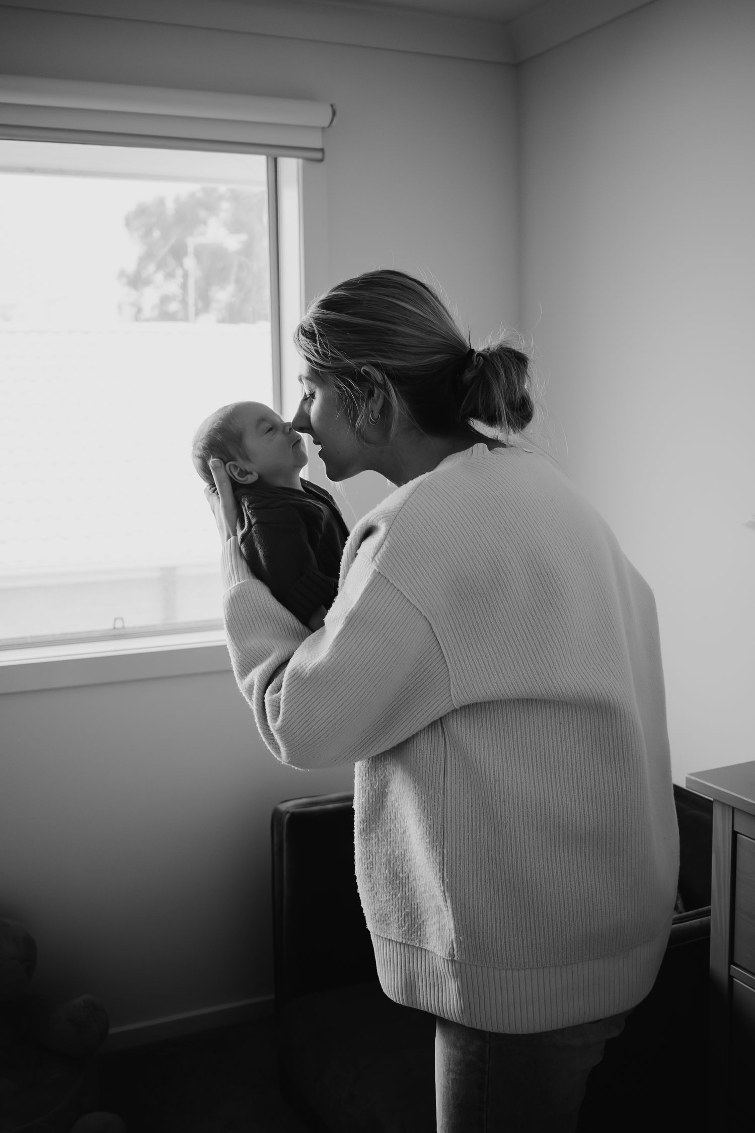 Mum touching noses with newborn.