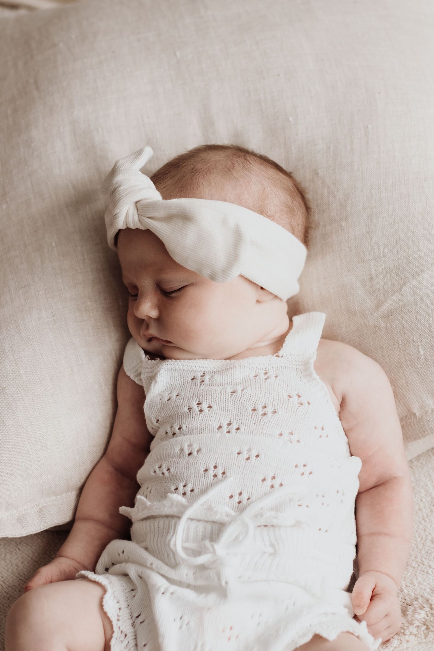 Baby sleeping on a cushion.
