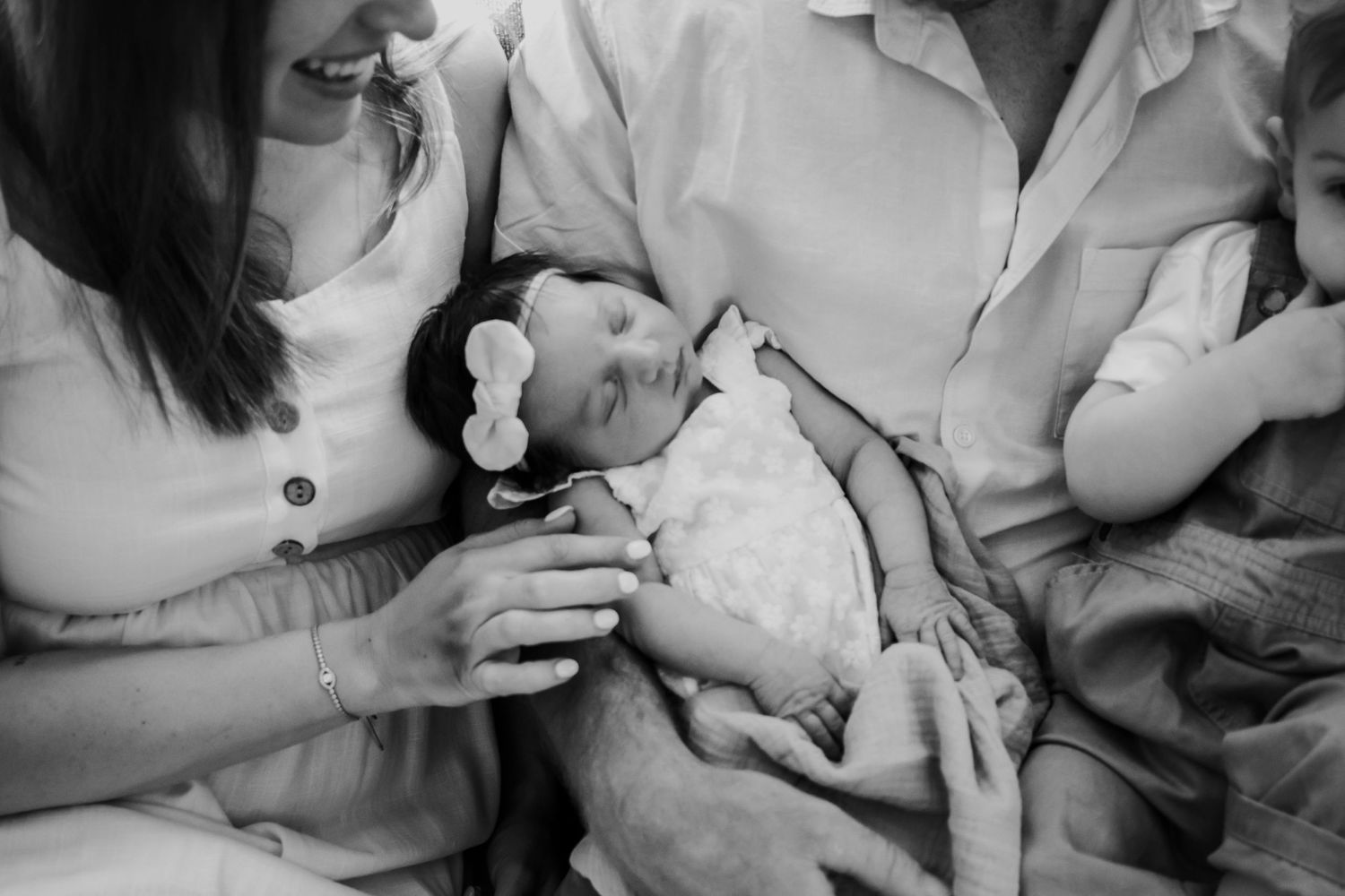 Close up of a family holding their newborn.