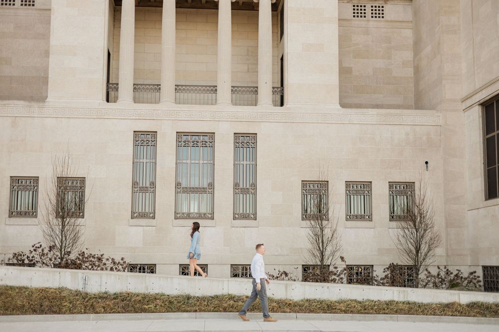 Wide view of a neoclassical stone building with columns and symmetrical windows.