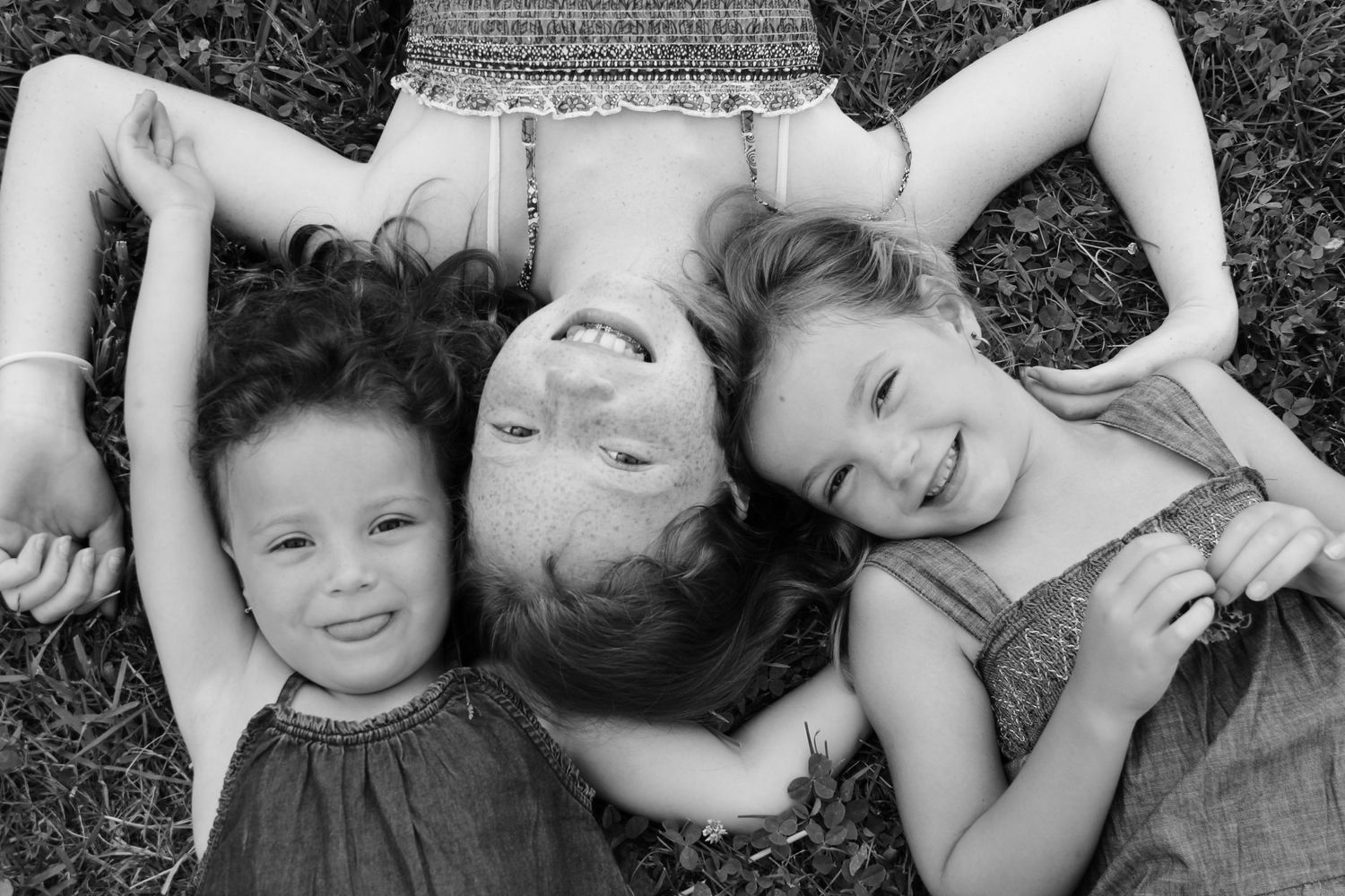 three girls laying in the grass
