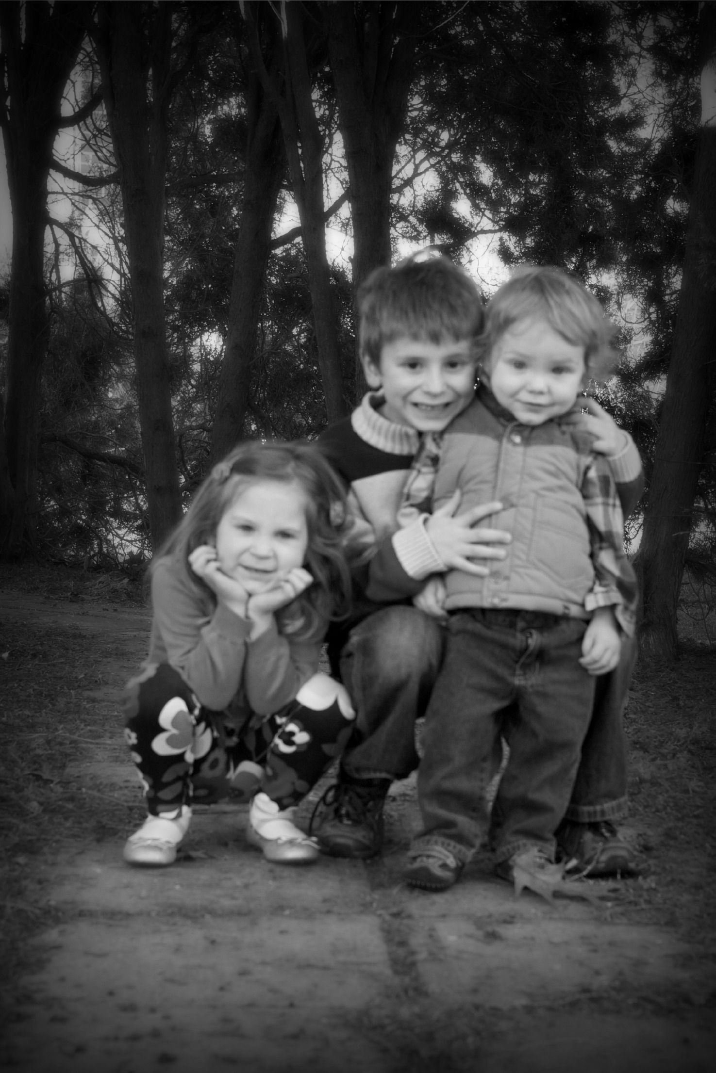 three children pose together happily