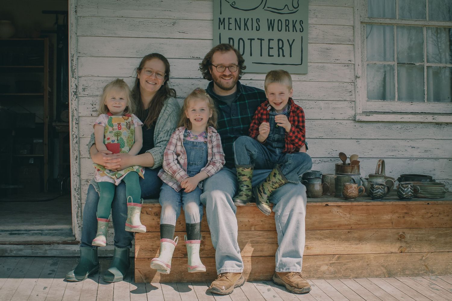 a young family pose happily