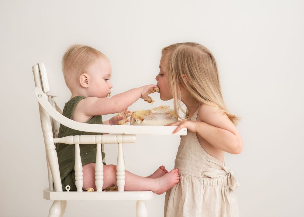 first birthday baby sharing cake with sibling natural milestone session Halifax