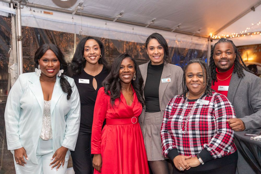Group of diverse professionals posing together at a networking event.