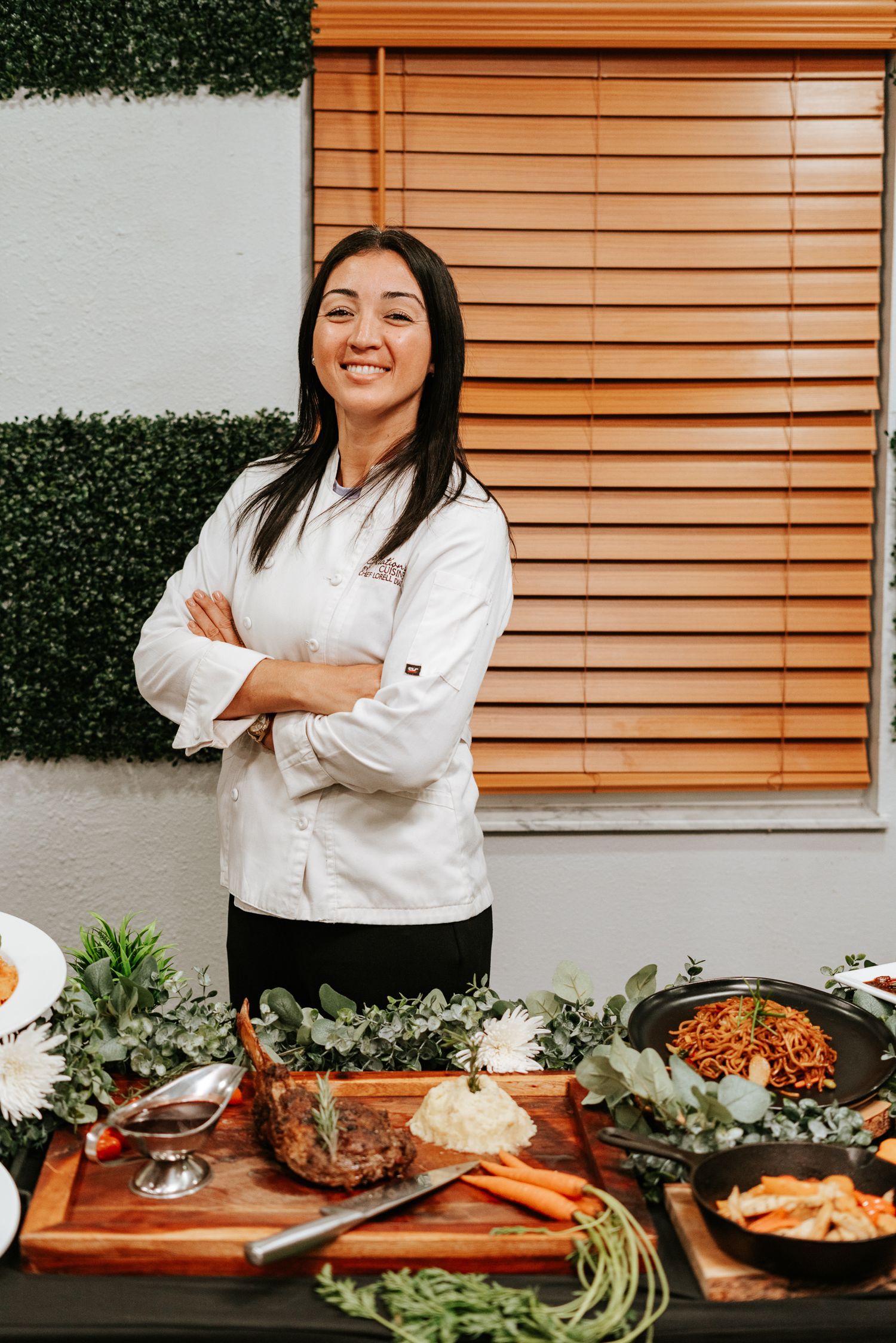 Catering presentation with various dishes and appetizers displayed on wooden table.
