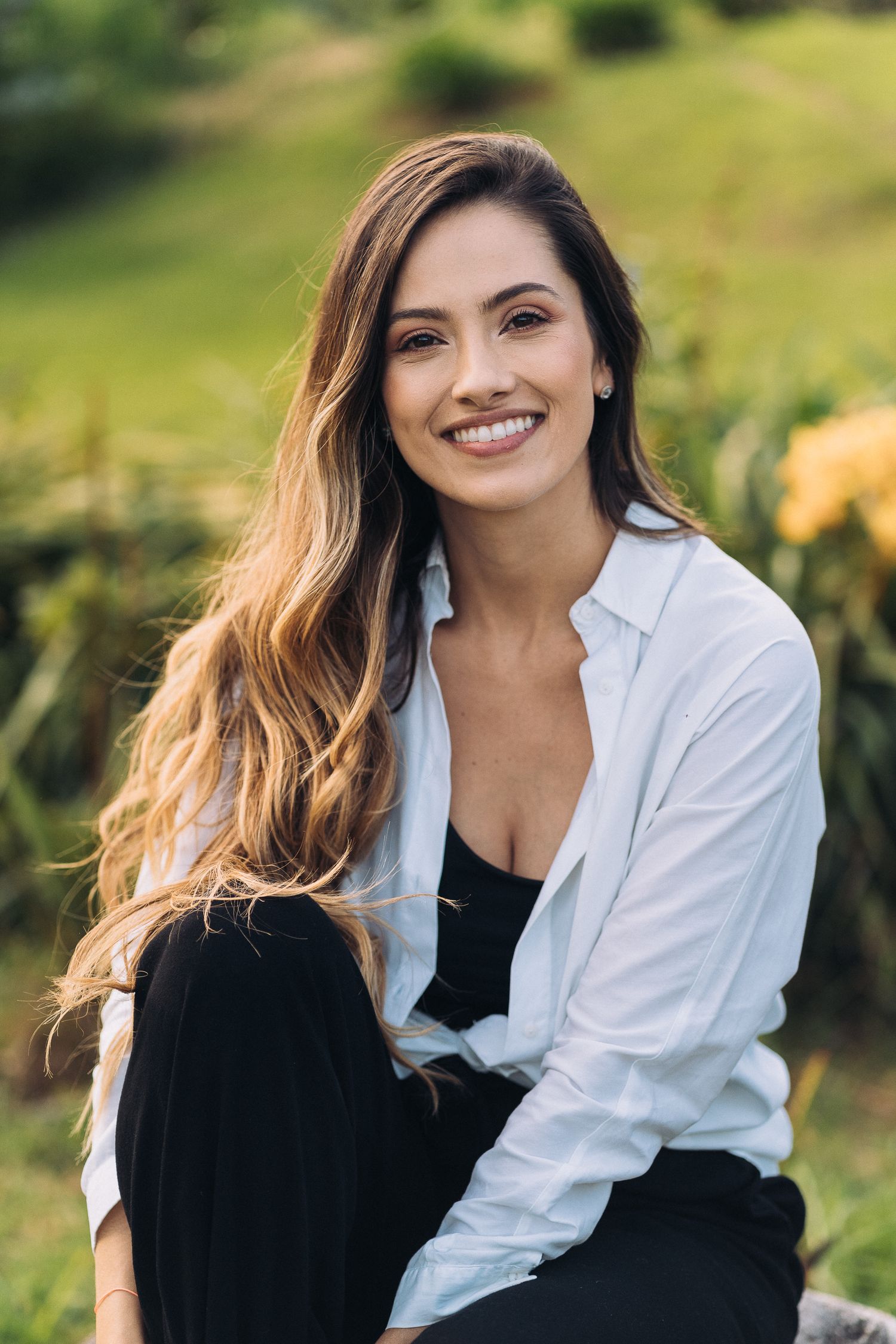 Natural lifestyle portrait in a garden setting with warm afternoon lighting.