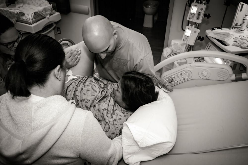 Medical team gathered around a patient's bedside during treatment.