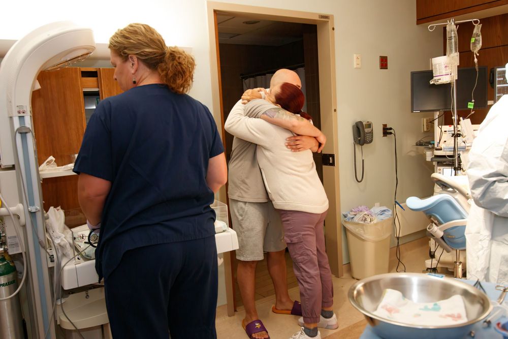 Emotional moment shared between family members in a hospital room.