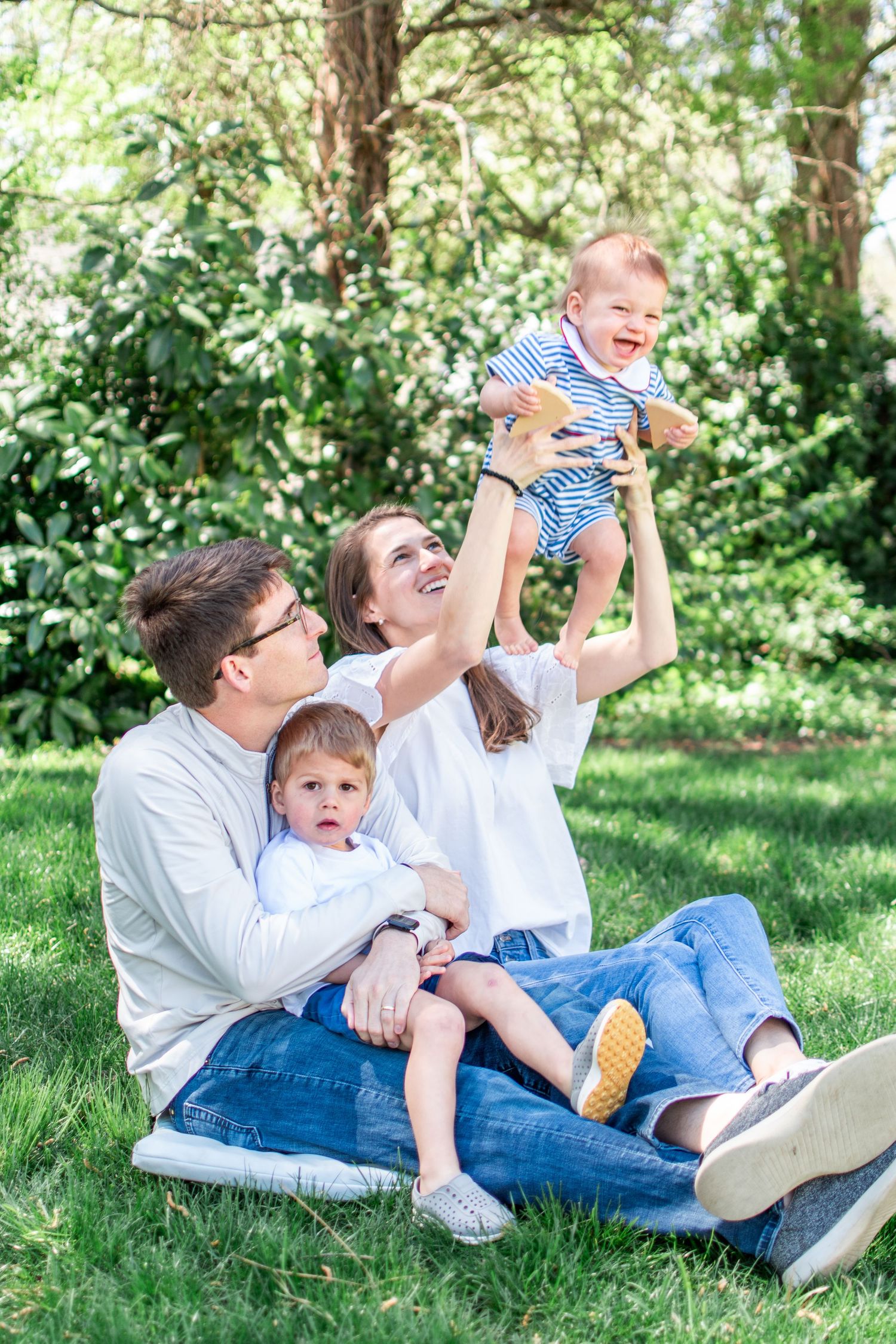 A family relaxes together in their back yard, soaking in a beautiful spring day.