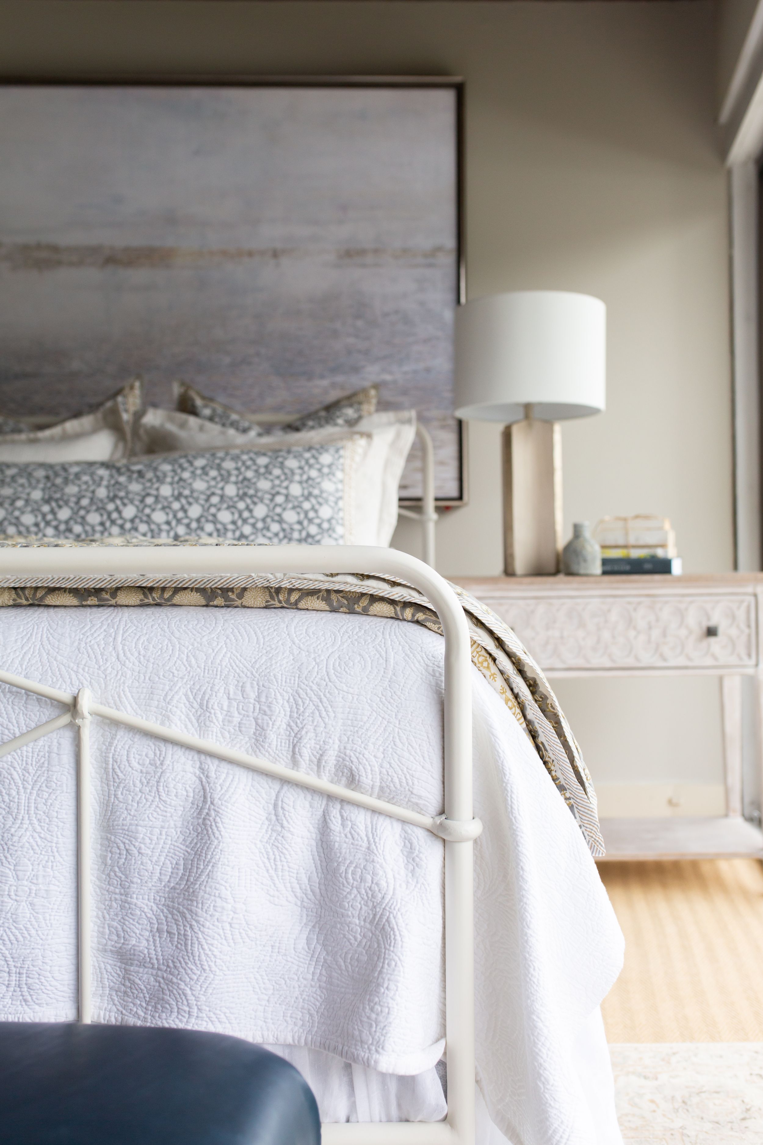 Elegant white bedroom featuring a traditional metal bed frame with crisp linens and neutral decor.
Commercial Photography