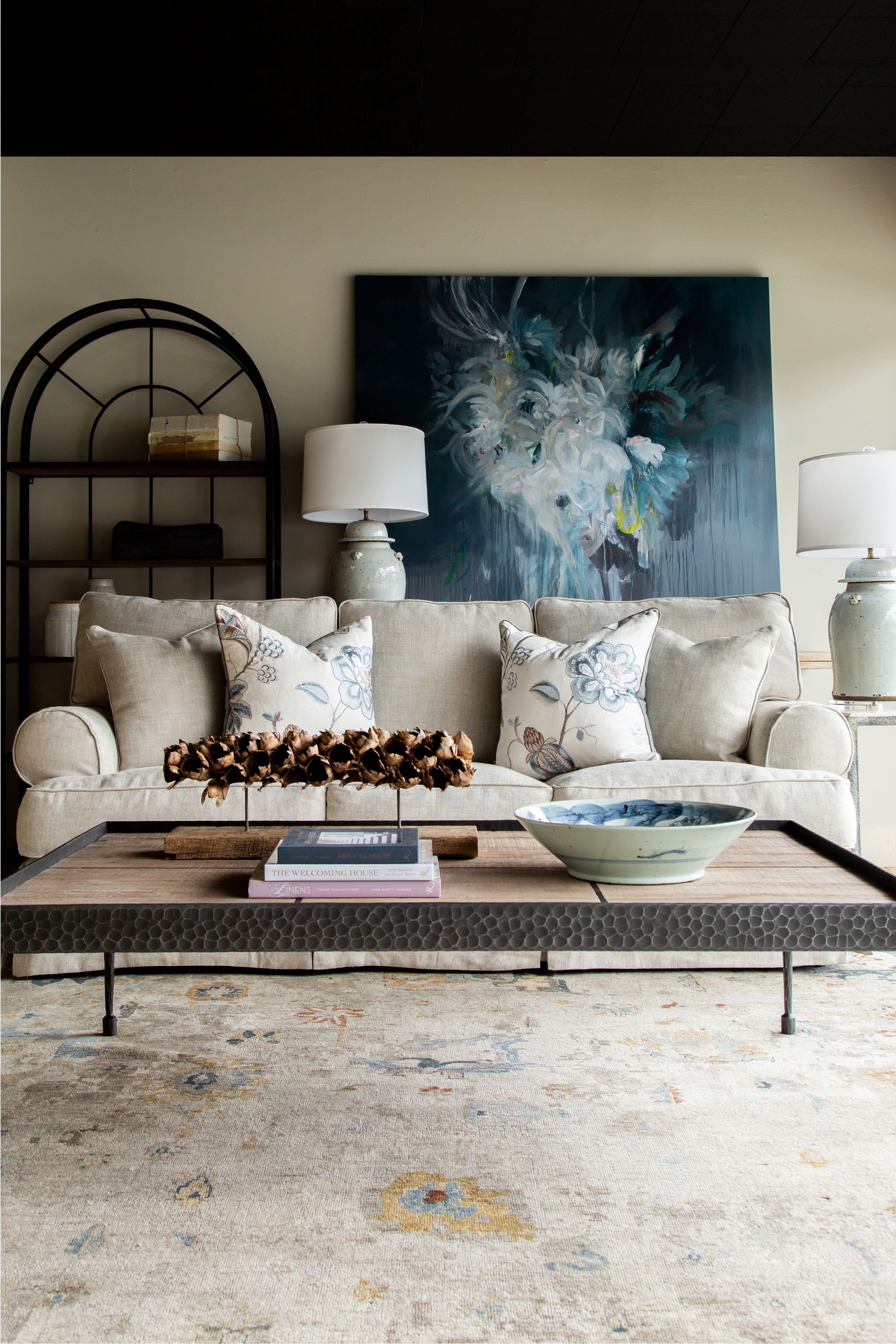 Living room with beige sofa, abstract blue artwork, and dried floral arrangement on a coffee table.
Commercial Photography