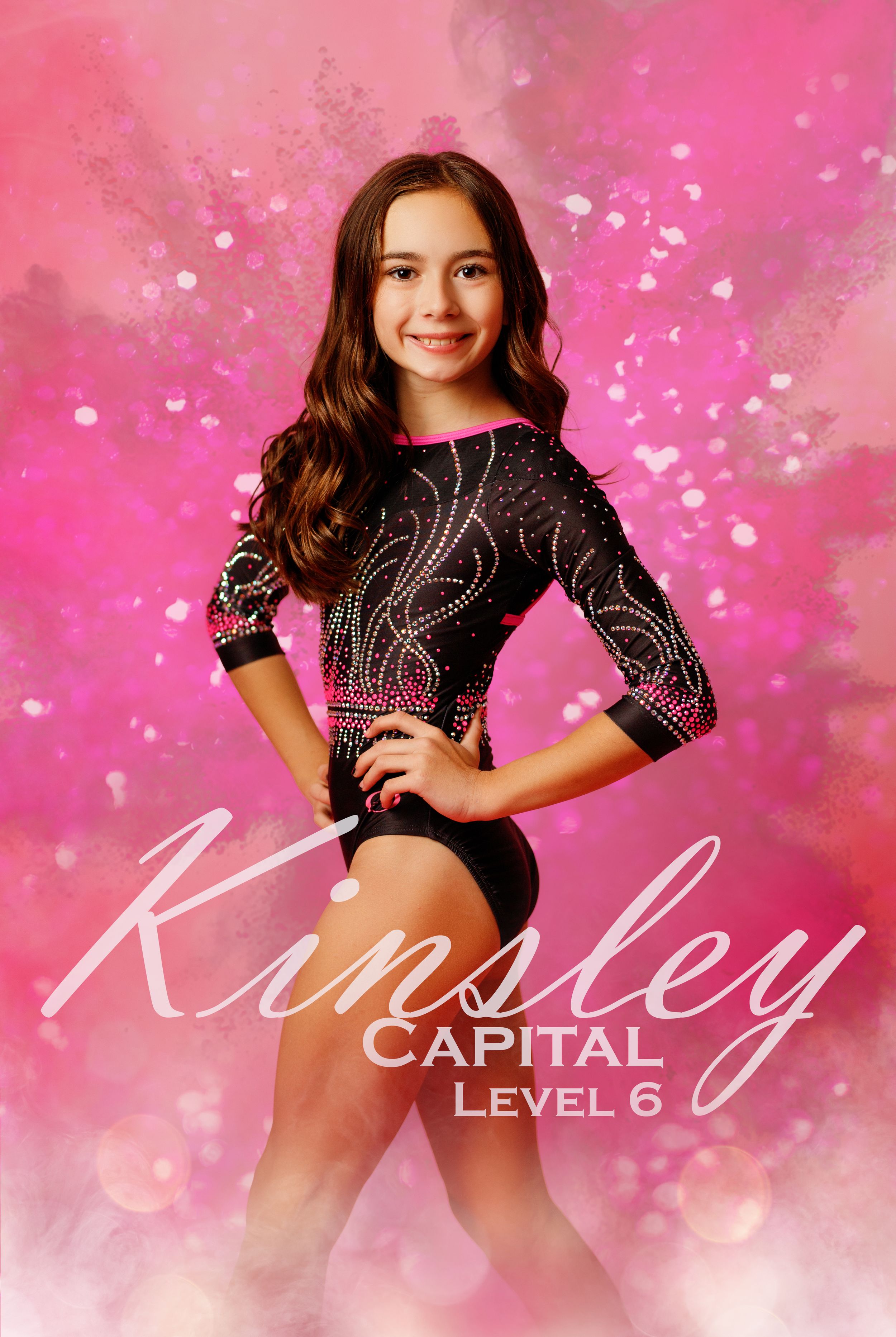 Young gymnast Kinsley poses in a black and pink rhinestone leotard for her Capital Level 6 gymnastics portrait.
