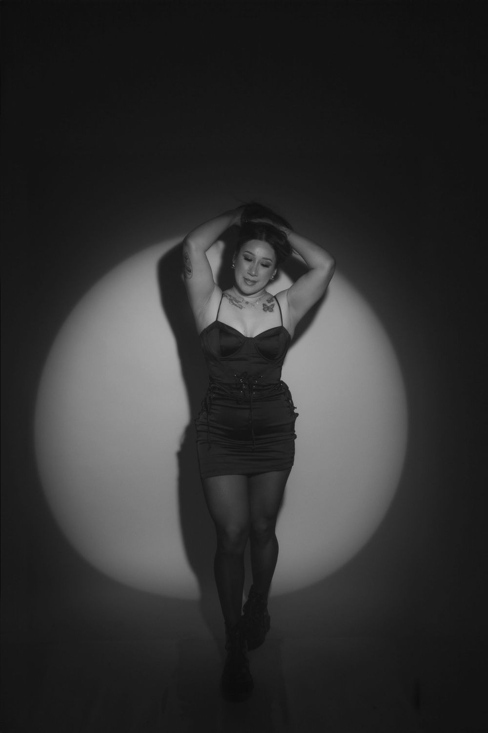 Dramatic black and white photo with spotlight effect creating moody atmosphere.