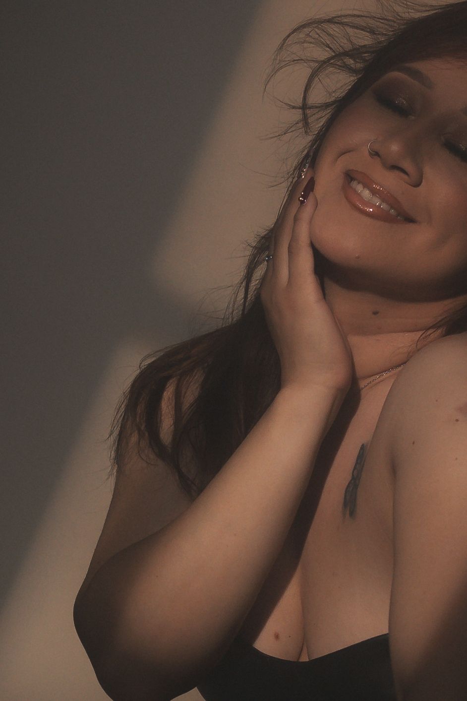 Intimate beauty portrait with warm tones and natural lighting.