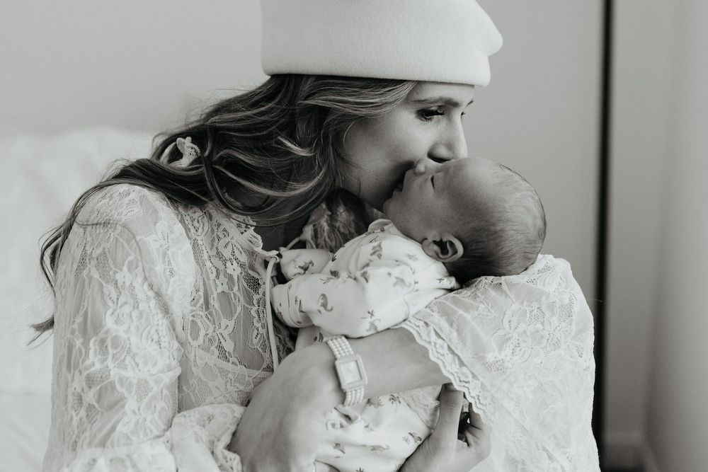 A series of intimate black and white wedding photos showing tender moments between a couple.