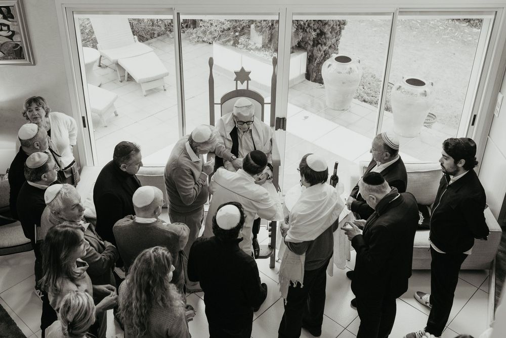 A black and white collage showing multiple views of people gathered in a queue or line formation.