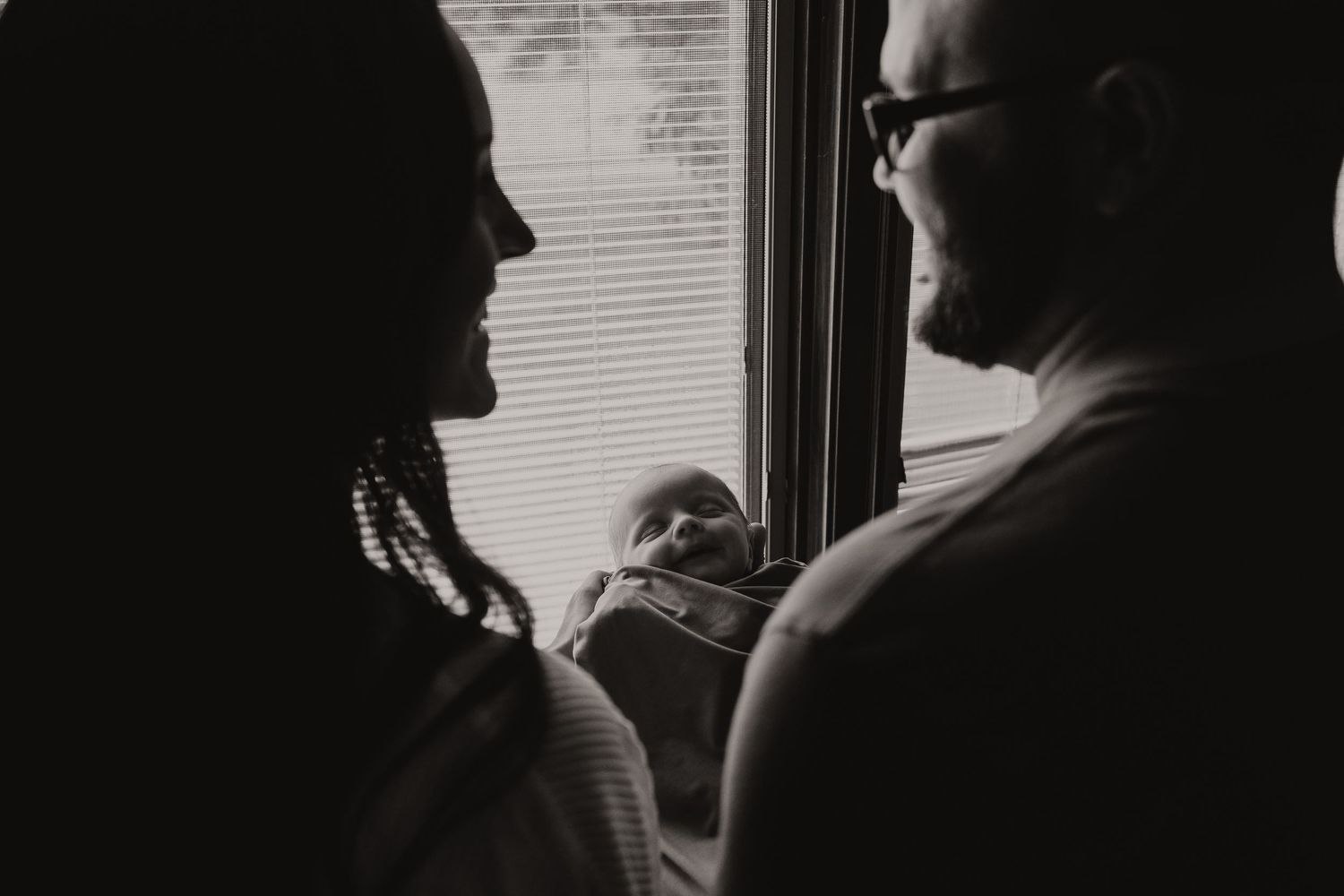 A black and white photo montage shows silhouettes of people looking out windows in different frames.
