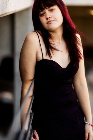 A person with red hair wearing a black sleeveless top poses in a series of connected portrait shots.
