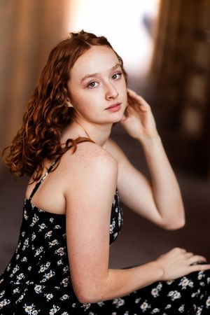 A collection of artistic portrait shots featuring someone in a black floral dress against a dark background.