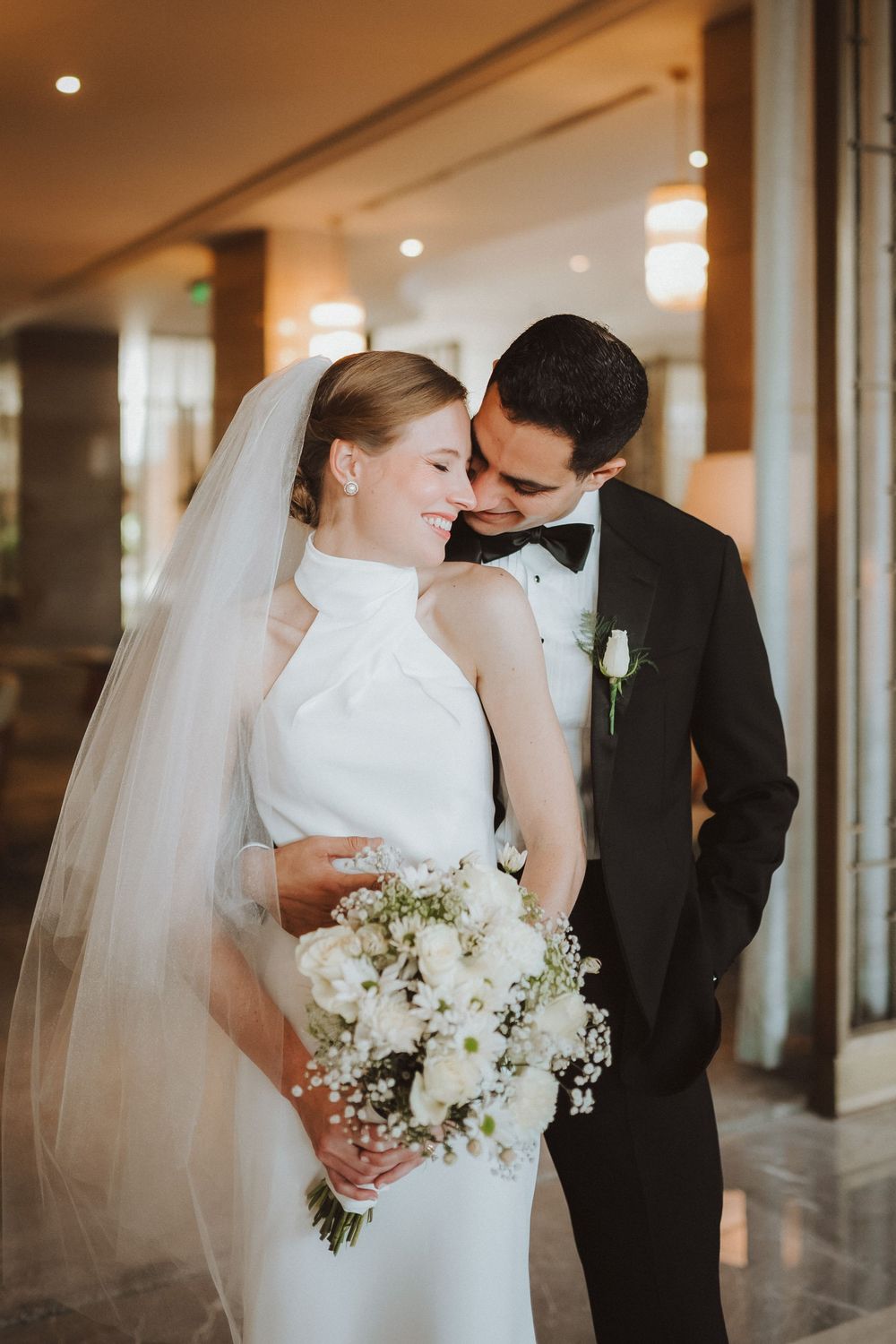 A romantic sequence of wedding photos showing a couple sharing intimate moments in an indoor venue with soft lighting.
