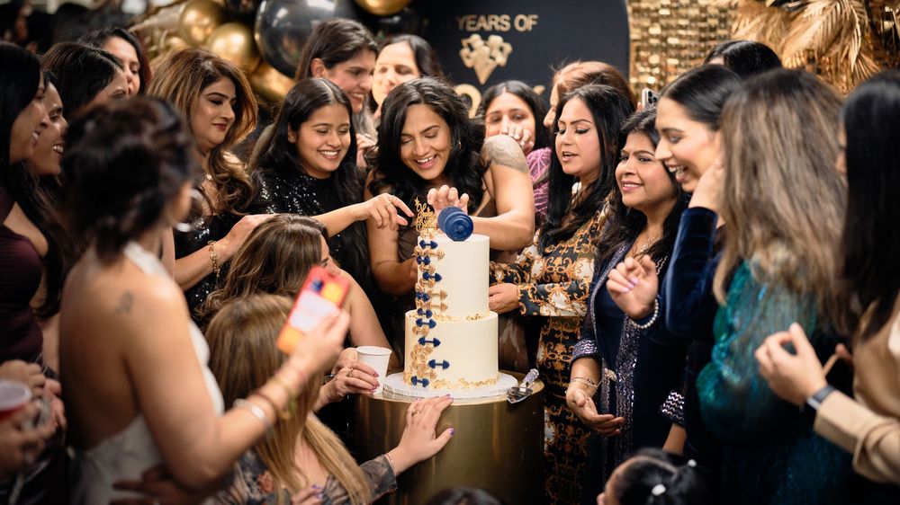 A group of party guests dancing and celebrating at a lively social gathering with a festive atmosphere.