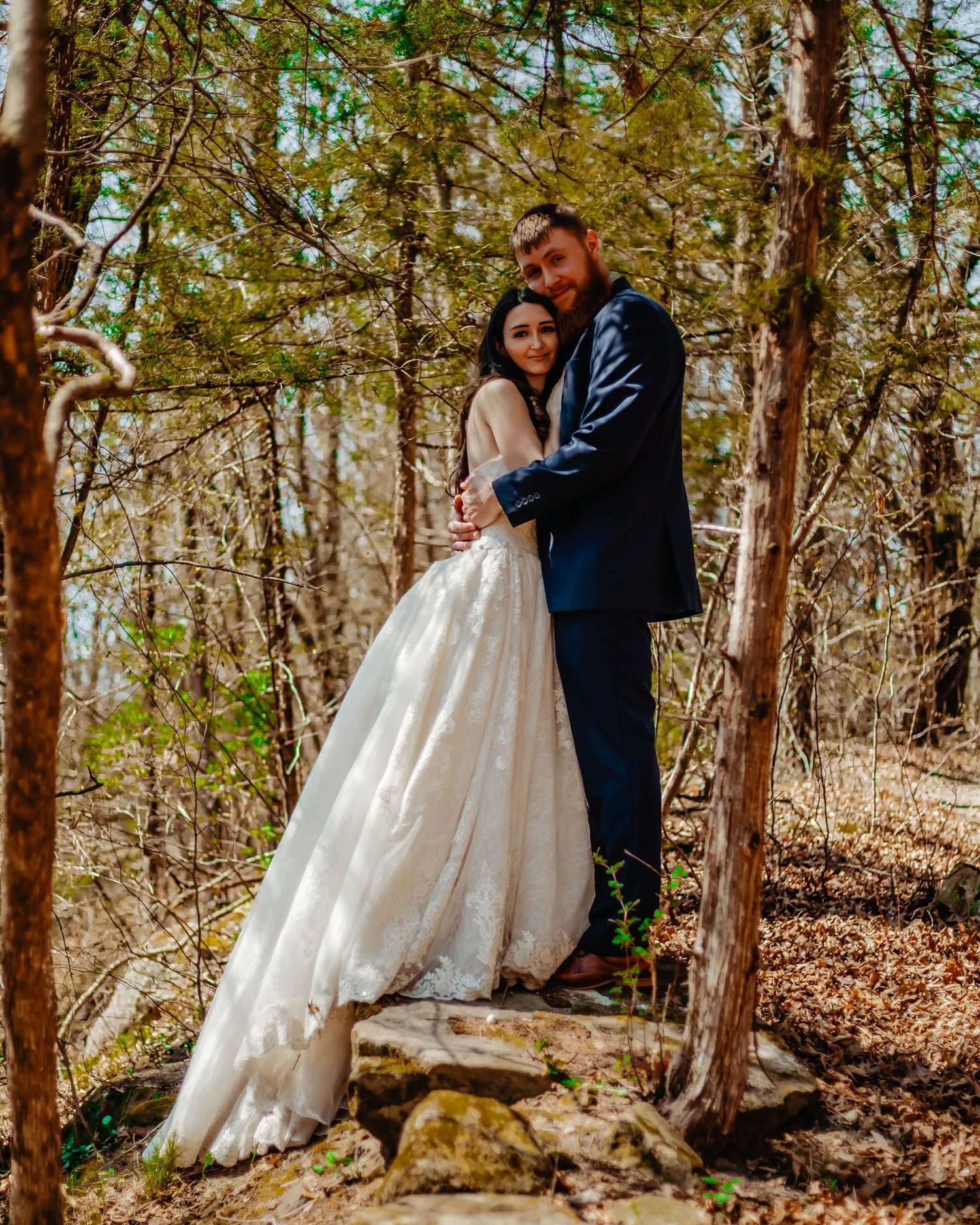 Romantic forest wedding portrait among autumn trees.