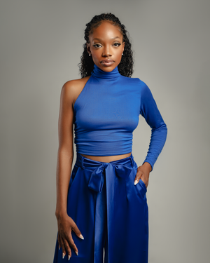 Stylish blue asymmetrical turtleneck top paired with matching wide-leg pants.
