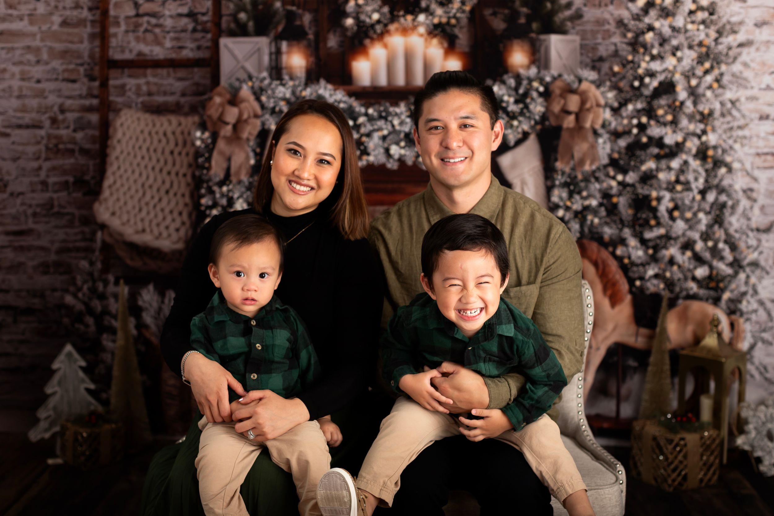 Cozy Christmas family photo with matching green and beige outfits against festive decor.