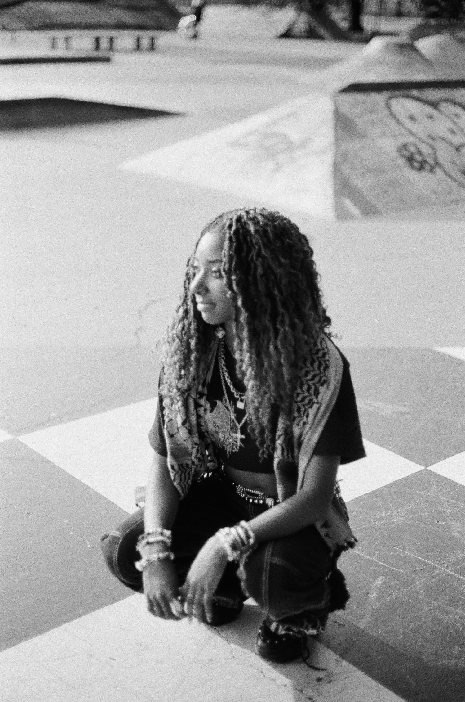 Artistic black and white photo sequence showing dynamic poses on concrete.
