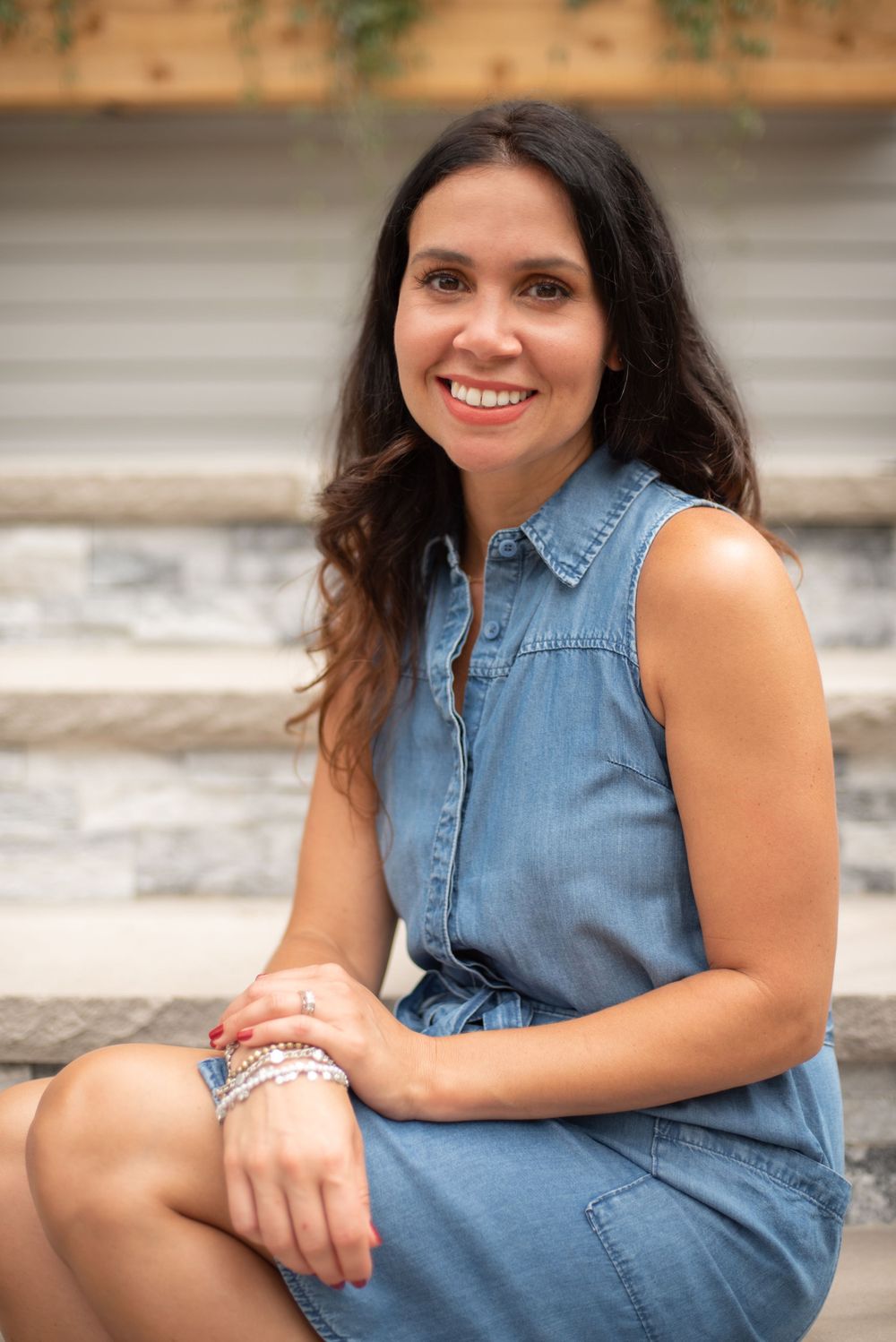 a branding portrait of a woman in blue dress on concrete steps in Middletown NJ