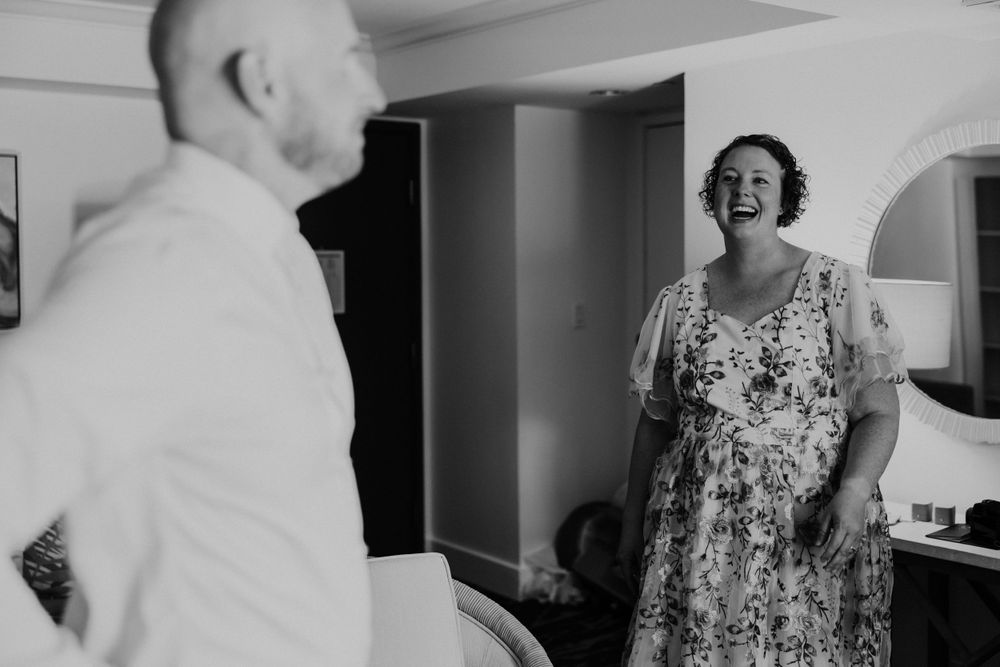 A joyful moment captured in black and white as someone shows off a floral dress.