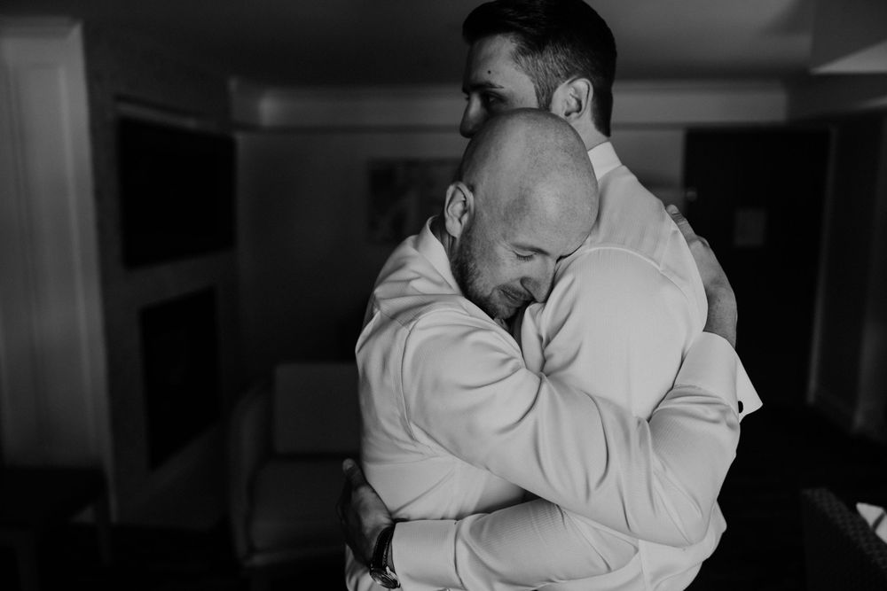 An emotional embrace captured in black and white during a special moment.