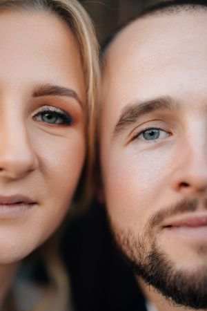 An intimate close-up portrait showcasing eyes and facial features in warm, natural lighting.
