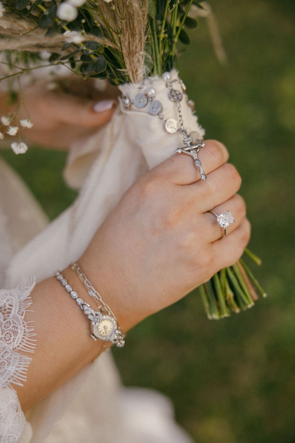 Close-up shots of elegant diamond engagement rings and wedding bands on a hand holding a white floral bouquet.