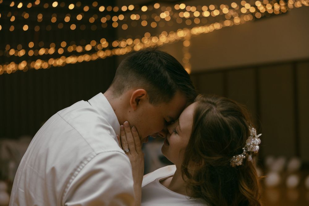 Wedding reception venue illuminated by warm string lights creating a romantic atmosphere.