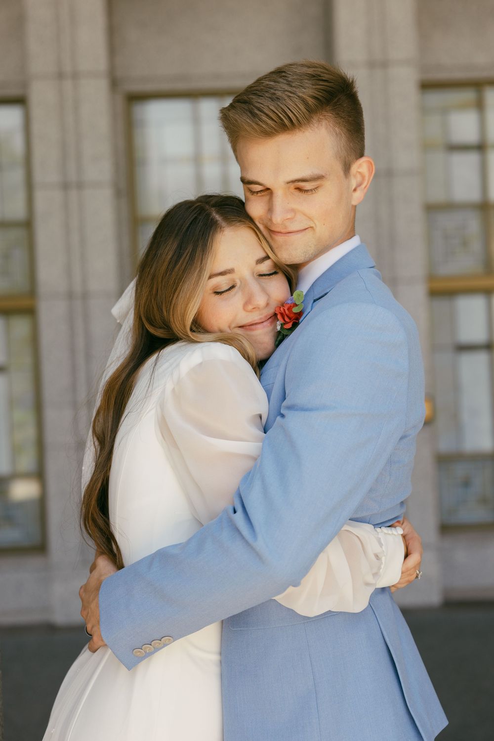 Romantic wedding couple embracing in a series of tender moments against a stone building backdrop.