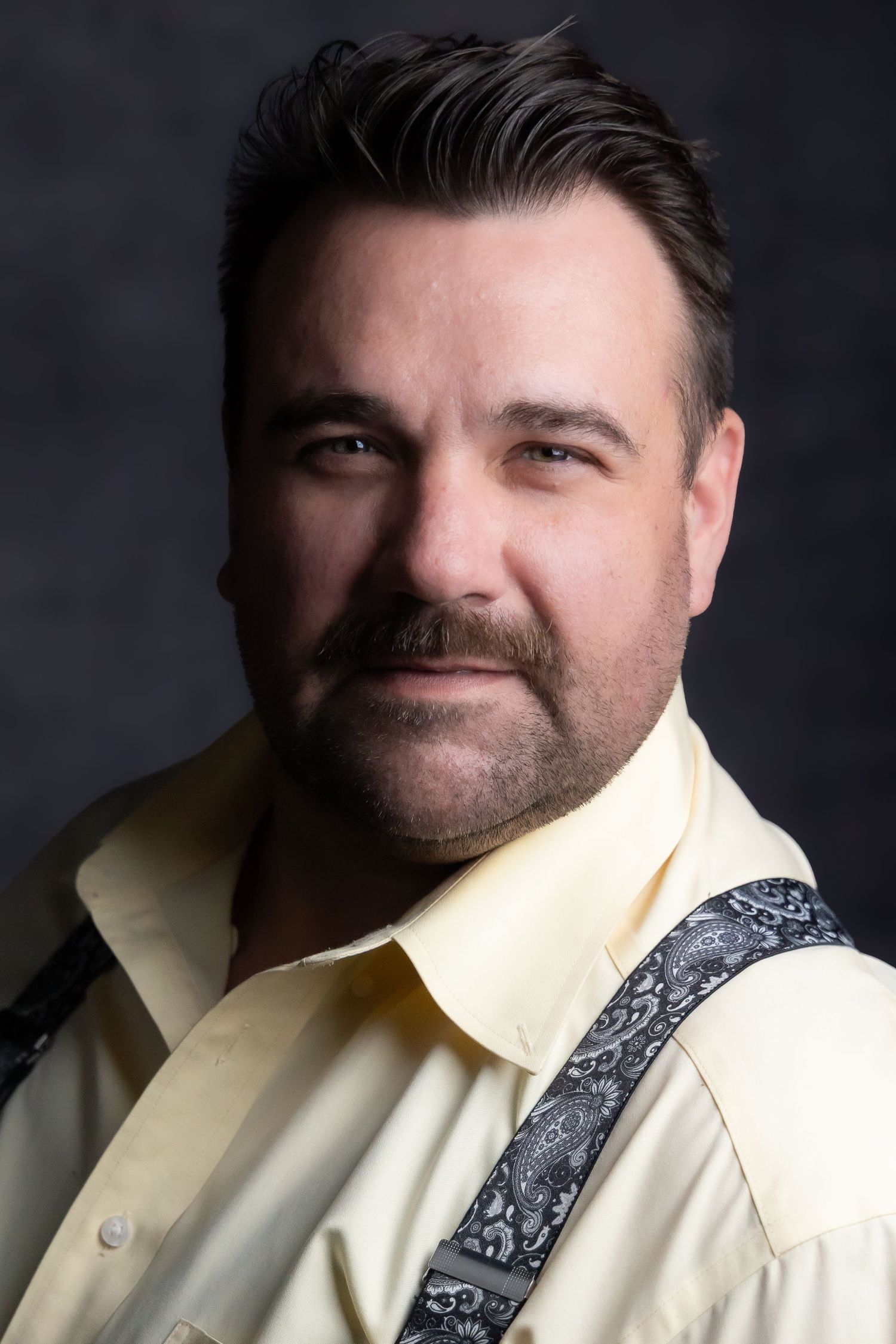headshot of an older gentleman with a beard and whitehair