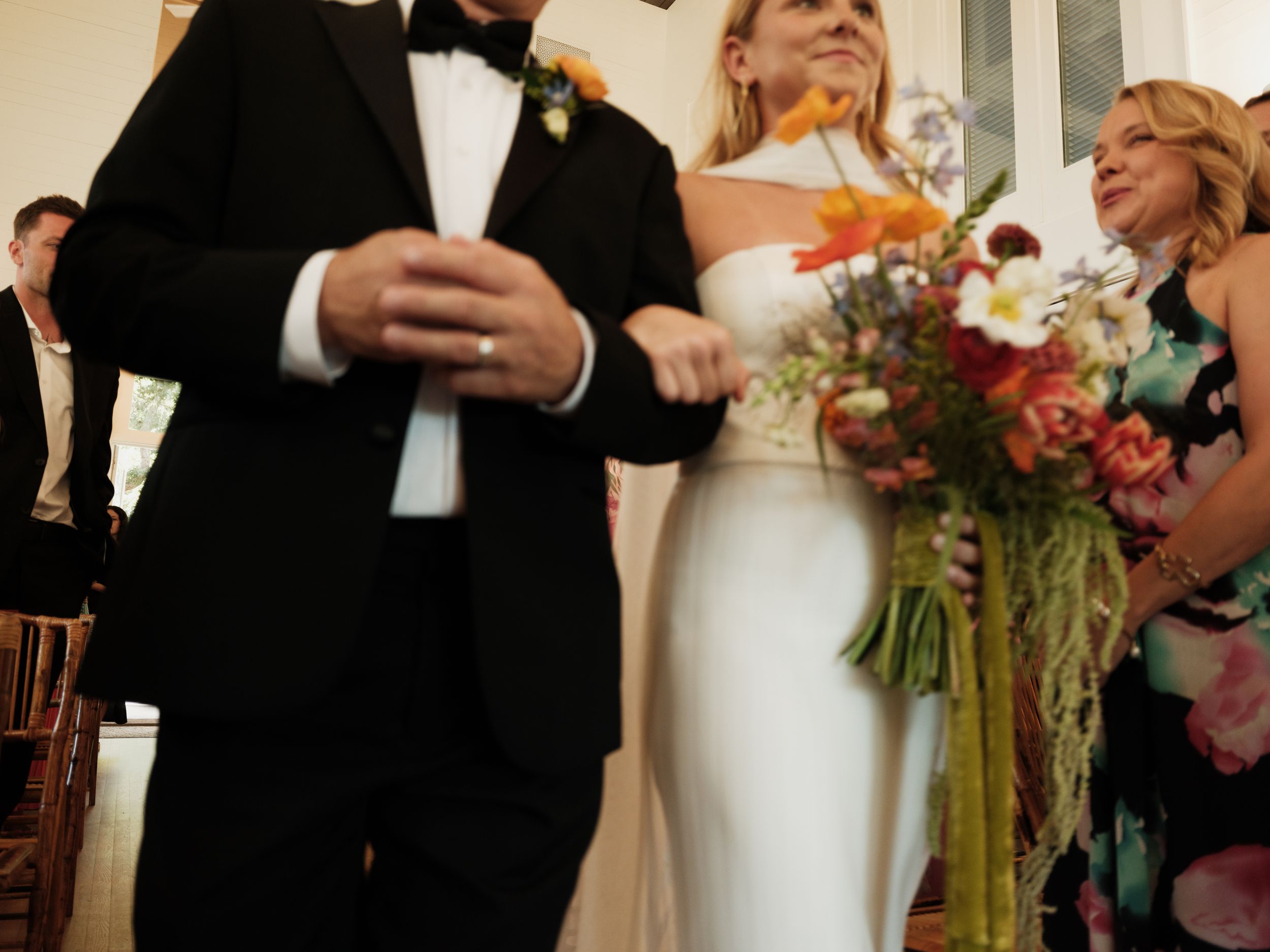 Wedding celebration candid moments captured in warm lighting with floral arrangements.
