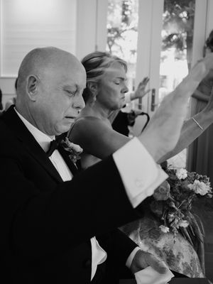 Black and white series of formal wedding party portraits with floral boutonnieres.