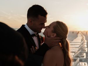 Intimate wedding moments captured in silhouette against a bright sky.