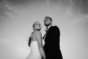 Black and white wedding portraits showing tender moments between newlyweds.