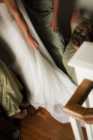 Motion sequence of white fabric flowing against a wooden floor.