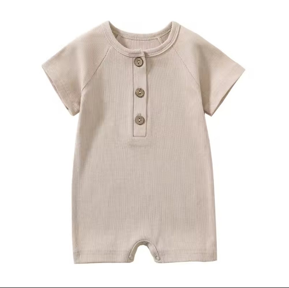 Beige ribbed cotton baby romper with short sleeves and three-button henley placket design.