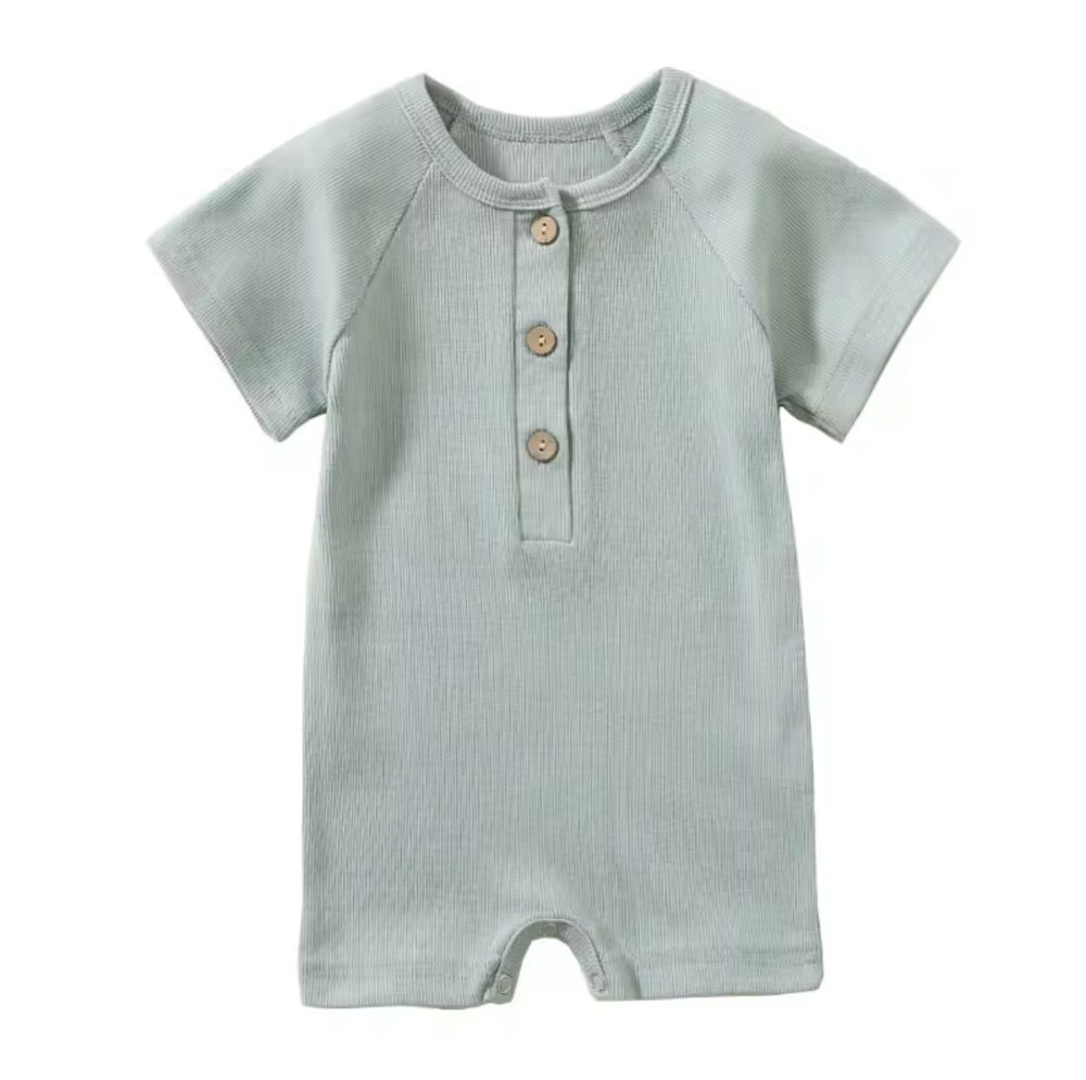 Light mint green baby romper with short sleeves and three wooden buttons at the neckline.