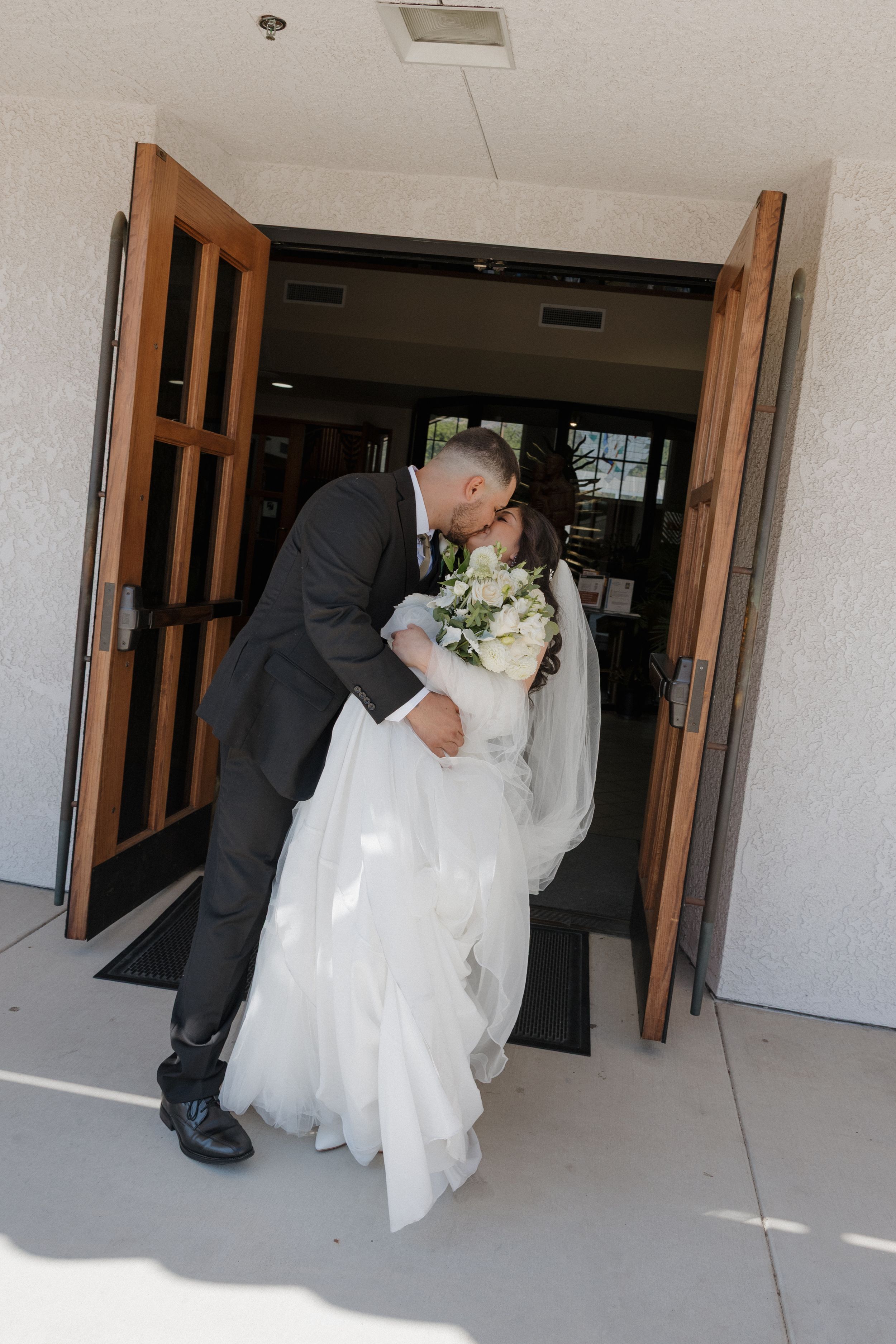 A romantic wedding dip kiss sequence shows the progression of a bride and groom's playful moment in a hallway.